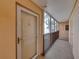 Hallway leading to unit 307, with elevator access, on an upper floor with palm tree view at 7665 Sun Island S Dr # 307, South Pasadena, FL 33707