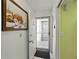 Hallway leading to elevator with storm door, and an art piece on the wall at 7665 Sun Island S Dr # 307, South Pasadena, FL 33707