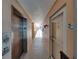 Hallway leading to unit 307, with elevator access, on an upper floor at 7665 Sun Island S Dr # 307, South Pasadena, FL 33707