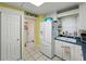 Bright kitchen featuring white appliances, cabinets, and tile flooring, offering a clean and functional space at 7665 Sun Island S Dr # 307, South Pasadena, FL 33707