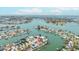 Gorgeous aerial view of waterfront property on canal with lush tropical landscaping, community and Gulf views at 7991 1St S Ave, St Petersburg, FL 33707