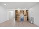 Stylish bar area with custom cabinetry, shelving, a wine cooler and elegant lighting, perfect for entertaining guests at 7991 1St S Ave, St Petersburg, FL 33707