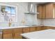 Modern kitchen features marble backsplash, stainless steel appliances, and blonde wood cabinets at 7991 1St S Ave, St Petersburg, FL 33707