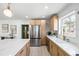 Modern kitchen features marble backsplash, kitchen island, stainless steel appliances, and blonde wood cabinets at 7991 1St S Ave, St Petersburg, FL 33707
