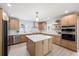 Modern kitchen features marble backsplash, kitchen island, stainless steel appliances, and blonde wood cabinets at 7991 1St S Ave, St Petersburg, FL 33707