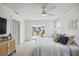 Stylish main bedroom with water views, ceiling fan, and slider to outdoors at 7991 1St S Ave, St Petersburg, FL 33707