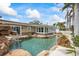 Backyard features a gorgeous pool, waterfall, and lush landscaping at 7991 1St S Ave, St Petersburg, FL 33707