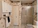 Bathroom featuring a shower and white patterned wallpaper at 810 Bluewater Dr, Sun City Center, FL 33573