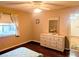 Bedroom with ceiling fan, wood floors, and dresser with decorative mirror at 810 Bluewater Dr, Sun City Center, FL 33573