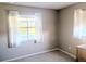 Neutral bedroom has carpet and windows with white curtains, creating a serene atmosphere at 810 Bluewater Dr, Sun City Center, FL 33573