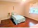 Cozy bedroom with wood floors, a twin bed and a window overlooking a lake at 810 Bluewater Dr, Sun City Center, FL 33573