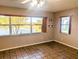 Light-filled bedroom with picturesque lake view, laminate floors, and natural light at 810 Bluewater Dr, Sun City Center, FL 33573