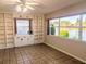 Bright, spacious room with built-in shelves and large windows overlooking a serene water view at 810 Bluewater Dr, Sun City Center, FL 33573