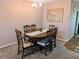 Dining room featuring classic wooden furniture, a chandelier, and a cozy atmosphere at 810 Bluewater Dr, Sun City Center, FL 33573