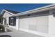Charming single story home featuring a screened in garage, a screened in porch, and neutral white brick at 810 Bluewater Dr, Sun City Center, FL 33573