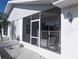 Enclosed front porch showcasing comfortable seating and a view of the landscaped yard at 810 Bluewater Dr, Sun City Center, FL 33573