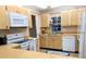 Functional kitchen with white appliances, laminate countertops, and ample cabinetry at 810 Bluewater Dr, Sun City Center, FL 33573