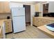 Functional kitchen with ample cabinet space, tile flooring and modern appliances at 810 Bluewater Dr, Sun City Center, FL 33573