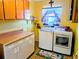 Bright laundry room with modern washer, dryer, and storage cabinets at 810 Bluewater Dr, Sun City Center, FL 33573