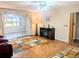 Inviting living room featuring parquet flooring, sliding glass doors, and a ceiling fan at 810 Bluewater Dr, Sun City Center, FL 33573