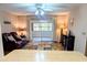 Comfortable living room featuring a ceiling fan, sliding glass doors, and a cozy seating area at 810 Bluewater Dr, Sun City Center, FL 33573