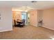 Open-concept living space with dining area, carpet flooring and modern lighting fixtures at 810 Bluewater Dr, Sun City Center, FL 33573