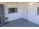 Cozy enclosed porch area with a small table, side window, and outdoor access at 810 Bluewater Dr, Sun City Center, FL 33573