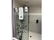This shower features gray tile and a decorative tree design on the glass door at 8503 Fantasia Park Way, Riverview, FL 33578