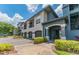 A spacious two-story condo building featuring attached garages and manicured landscaping at 8517 Island Breeze Ln # 106, Temple Terrace, FL 33637