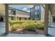 Landscaped exterior courtyard featuring trimmed hedges, garden areas, and connecting walkways at 8517 Island Breeze Ln # 106, Temple Terrace, FL 33637