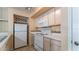 A bright kitchen featuring white appliances, laminate countertops and neutral walls at 8517 Island Breeze Ln # 106, Temple Terrace, FL 33637