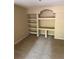 Carpeted living room featuring a decorative alcove with built-in shelving and storage at 8517 Island Breeze Ln # 106, Temple Terrace, FL 33637