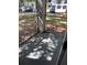 Screened porch with a concrete floor, offering a view of parking area and landscaping at 8517 Island Breeze Ln # 106, Temple Terrace, FL 33637