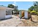 Fenced backyard featuring a greenhouse, patio, and space for gardening at 8696 118Th St, Seminole, FL 33772