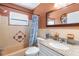 Cozy bathroom with granite vanity, shower-tub combo, and decorative accents at 8696 118Th St, Seminole, FL 33772