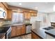 Well-lit kitchen featuring stainless steel appliances, wood cabinetry, and tiled backsplash at 8696 118Th St, Seminole, FL 33772