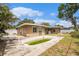Backyard featuring a green pool, grass, trees and the exterior of the home at 109 S Nimbus Ave, Clearwater, FL 33765