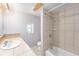 Bathroom featuring a sink, toilet, shower and beige tile at 109 S Nimbus Ave, Clearwater, FL 33765