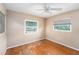 Bedroom with hardwood floors, ceiling fan, and natural light offers a serene and comfortable atmosphere at 109 S Nimbus Ave, Clearwater, FL 33765