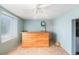 Bonus room featuring wood-paneled bar, refrigerator, ceiling fan, and blue walls, ideal for relaxation and entertaining at 109 S Nimbus Ave, Clearwater, FL 33765