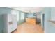 Bonus room with wood-paneled bar, refrigerator, ceiling fan, and light blue walls. Perfect for entertainment or additional storage at 109 S Nimbus Ave, Clearwater, FL 33765