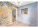 Dining room with a stone accent wall and an opening into the kitchen at 109 S Nimbus Ave, Clearwater, FL 33765
