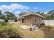 View of the garage with a driveway and a partially visible backyard with a pool at 109 S Nimbus Ave, Clearwater, FL 33765