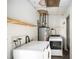 Laundry room with washer, dryer, hot water heater, and some shelving and storage at 109 S Nimbus Ave, Clearwater, FL 33765