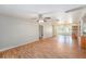 Open-concept living space with wood floors, a ceiling fan, and views into the kitchen at 109 S Nimbus Ave, Clearwater, FL 33765