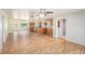 Spacious living room with an open floor plan, wood floors, and a kitchen view at 109 S Nimbus Ave, Clearwater, FL 33765