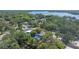 An aerial view of neighborhood with tree-lined streets and homes with swimming pools and fenced yards at 11709 N Armenia Ave, Tampa, FL 33612