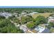 Aerial view of a home in a wooded residential neighborhood, near school and community sports field at 11709 N Armenia Ave, Tampa, FL 33612