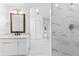 Bright bathroom featuring a vanity and walk-in shower with white marble tile at 11709 N Armenia Ave, Tampa, FL 33612