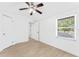Bedroom featuring modern floors, a ceiling fan, and a large window for ample natural light at 11709 N Armenia Ave, Tampa, FL 33612